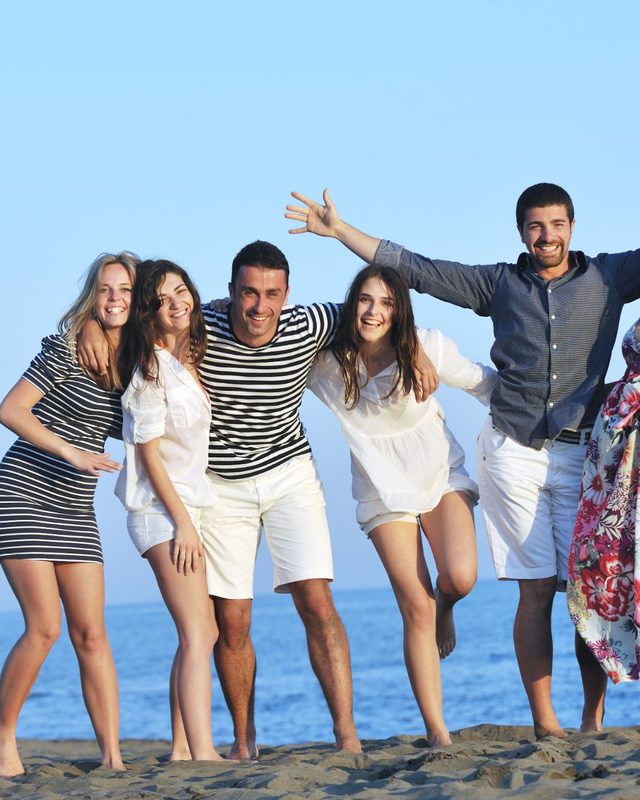 Friends laughing on the beach